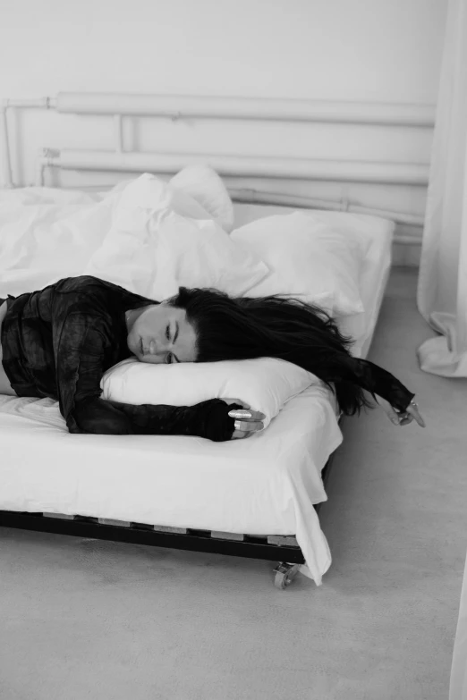 a woman lies on a bed and is exhausted