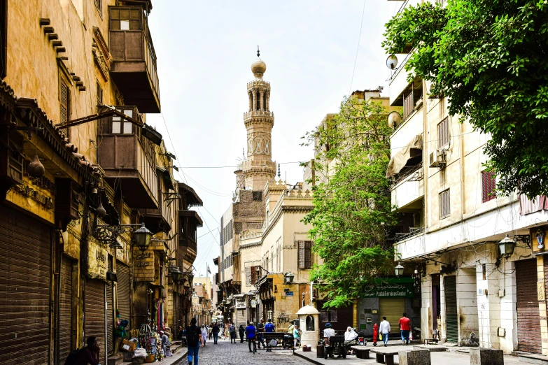 an old city street with several pedestrians walking on it