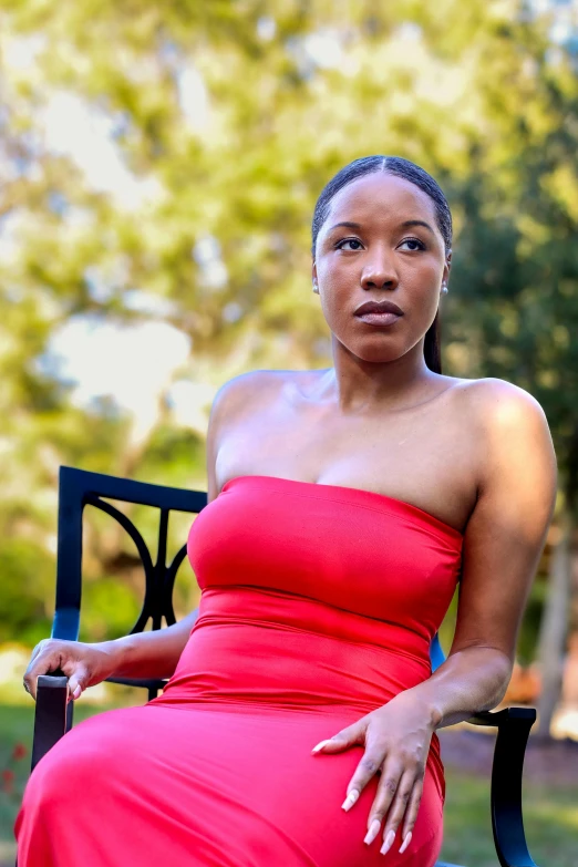 a young lady in a red dress posing for the camera