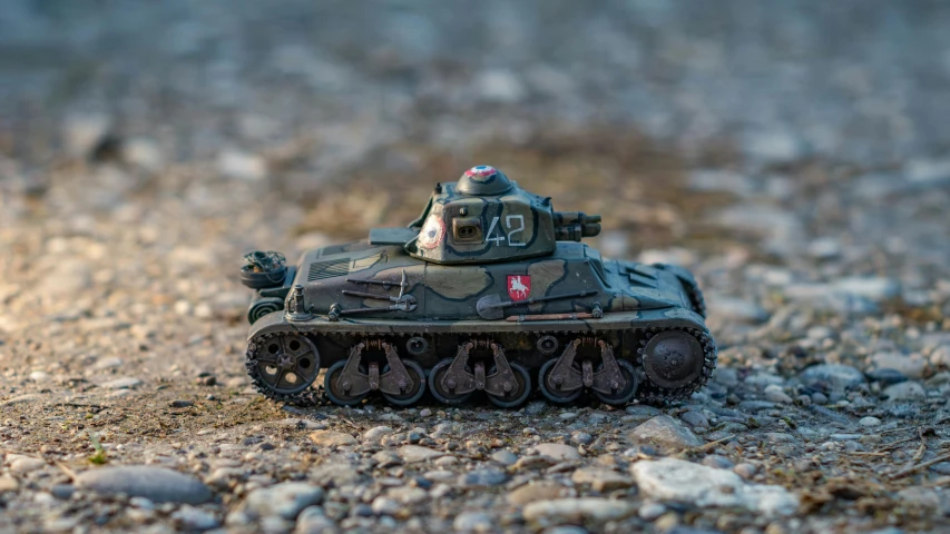 a toy tank is sitting on the ground