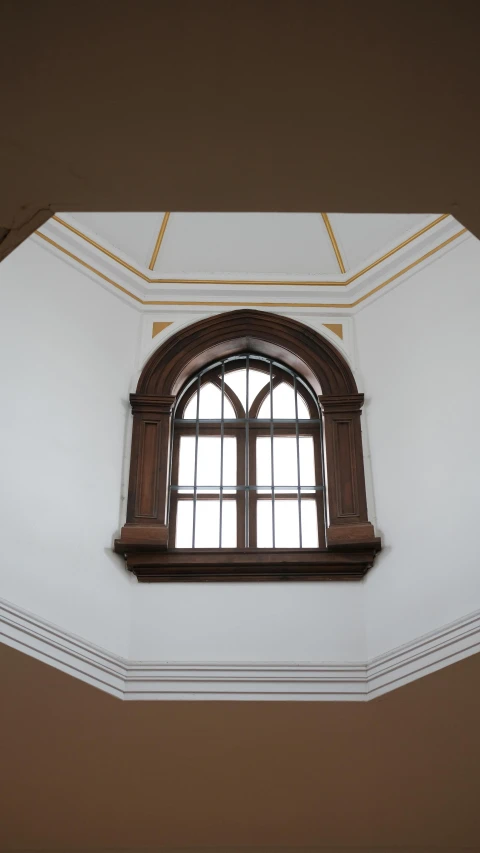 the windows have been set high in a wall with golden trim