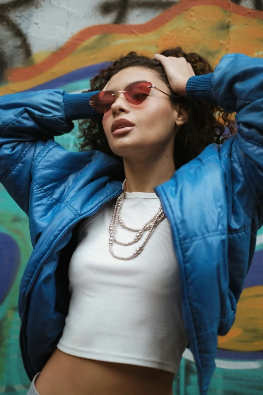 an image of a woman wearing shades and wearing a blue jacket