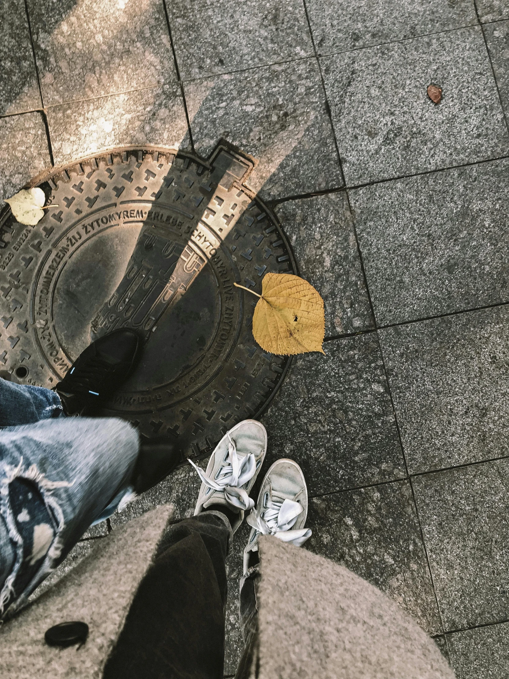 the legs of a person standing in the street