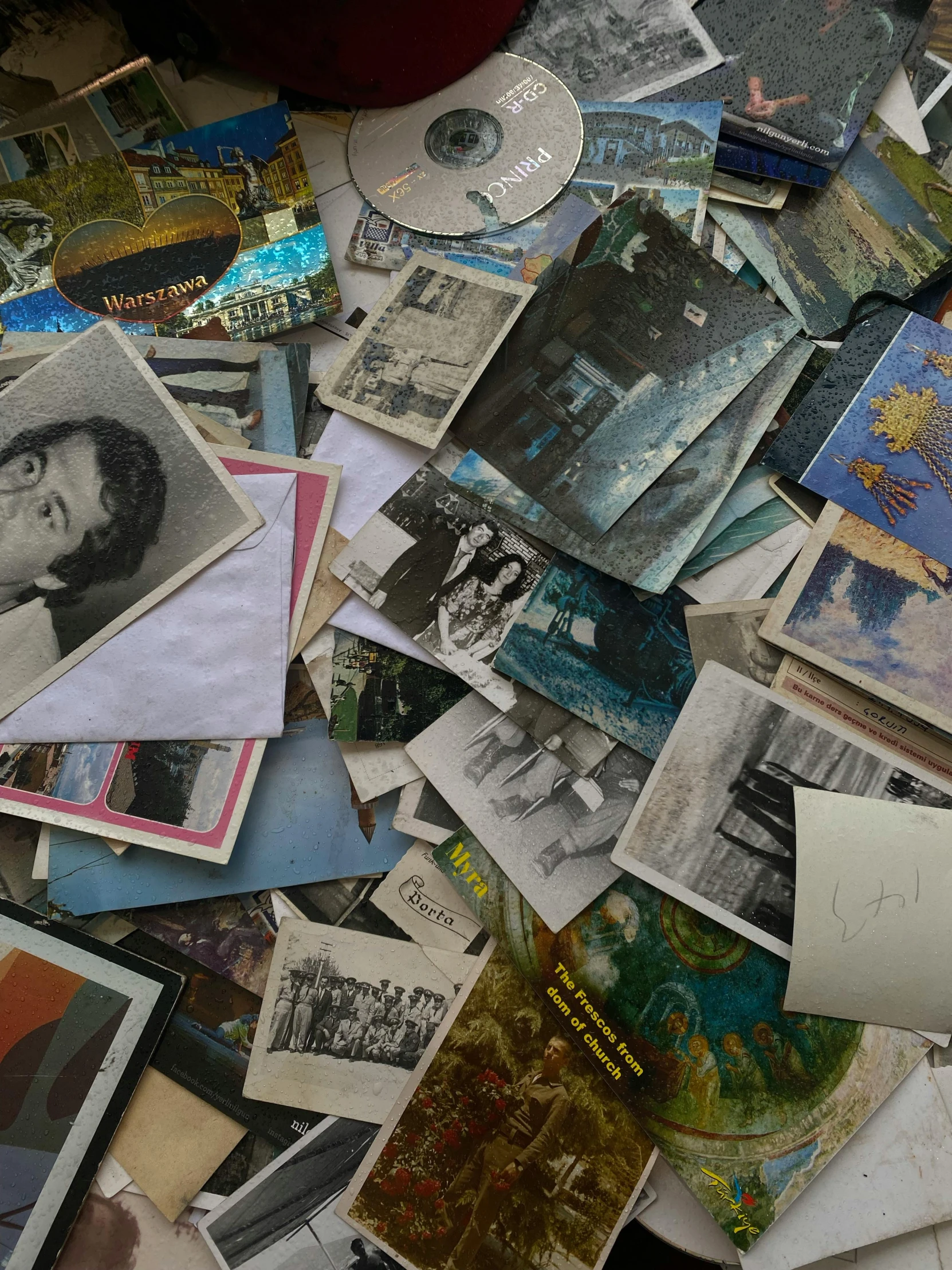 lots of old and damaged pographs sitting on a table