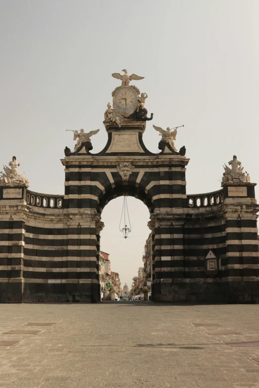 a man walking down a street next to an archway