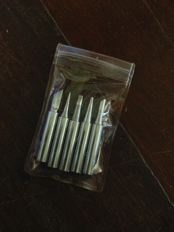 an empty case contains several toothbrushes that are in the package