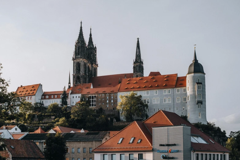 a large cathedral towers behind some old houses