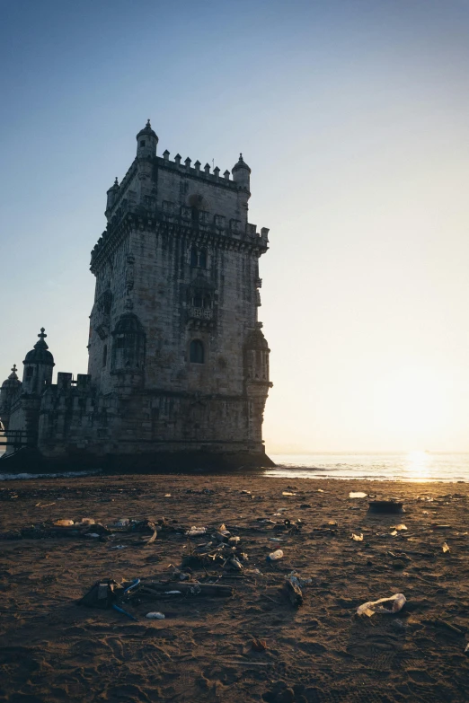 a tower stands over a beach with an ocean view