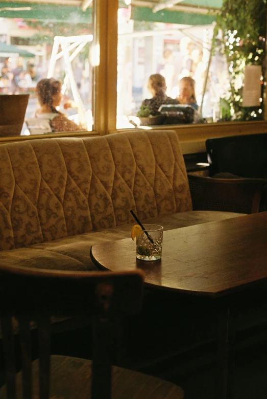 tables and chairs in a restaurant with view of store window