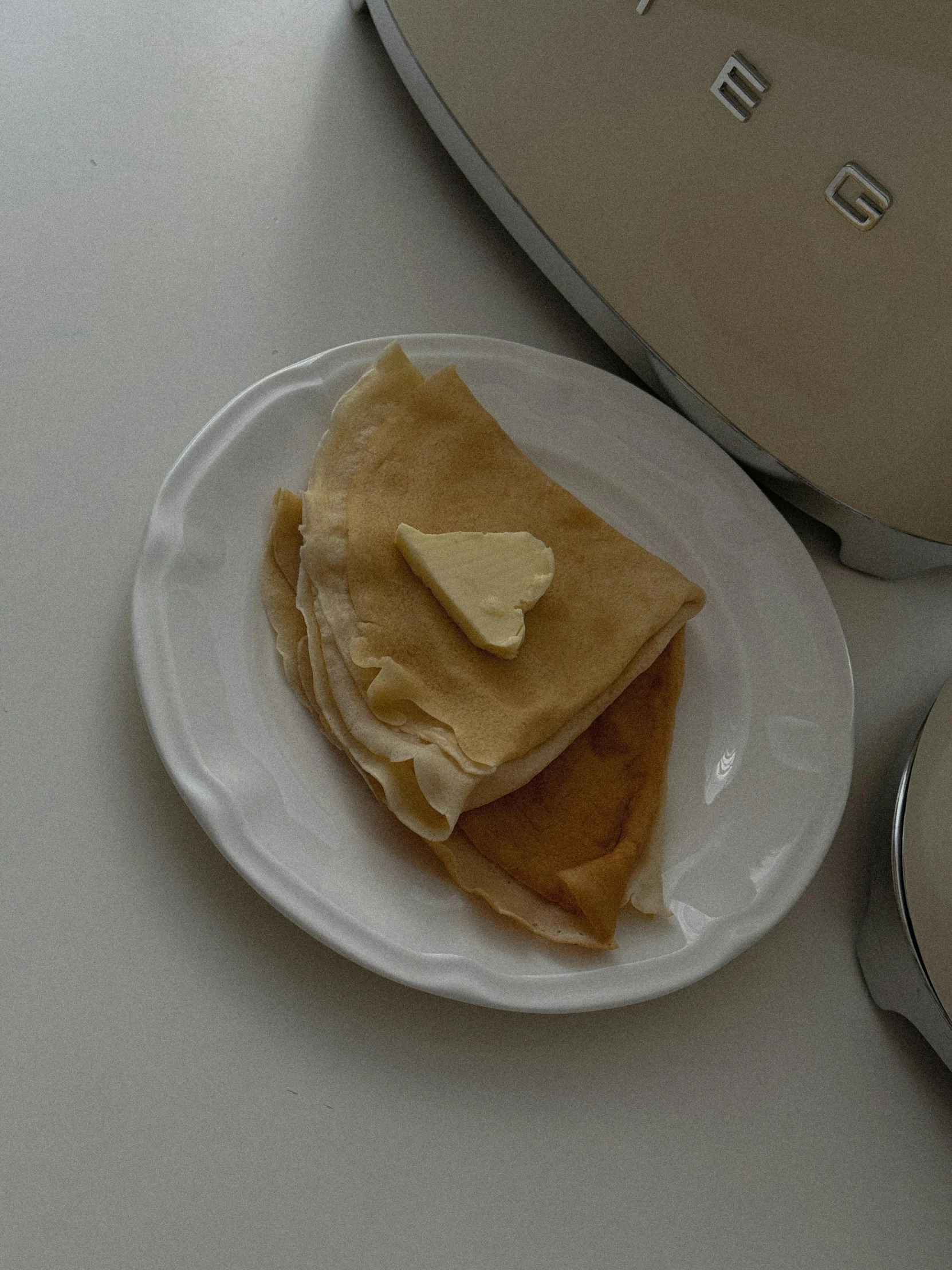 some food sits on a plate near an oven