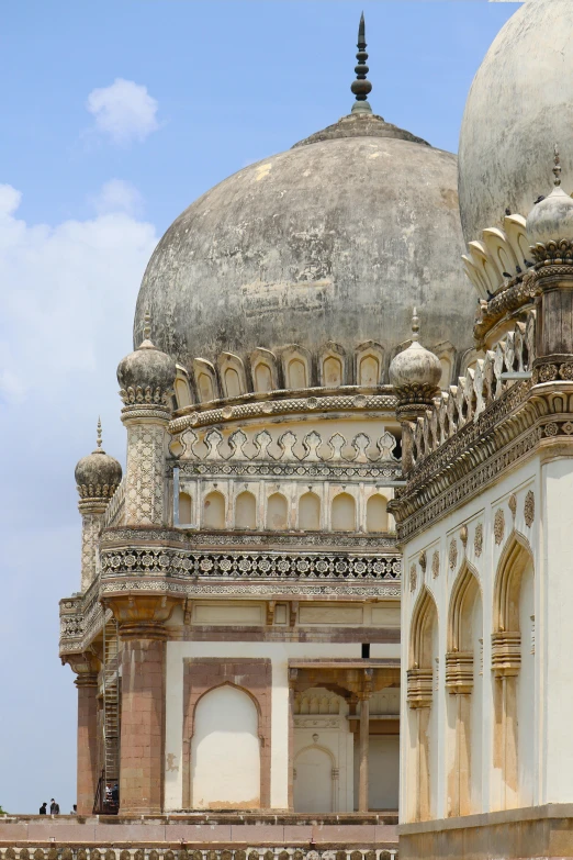 a white and brown structure with windows on top