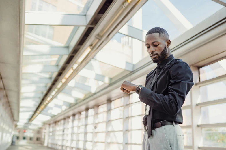 a man checking his phone while standing in the city