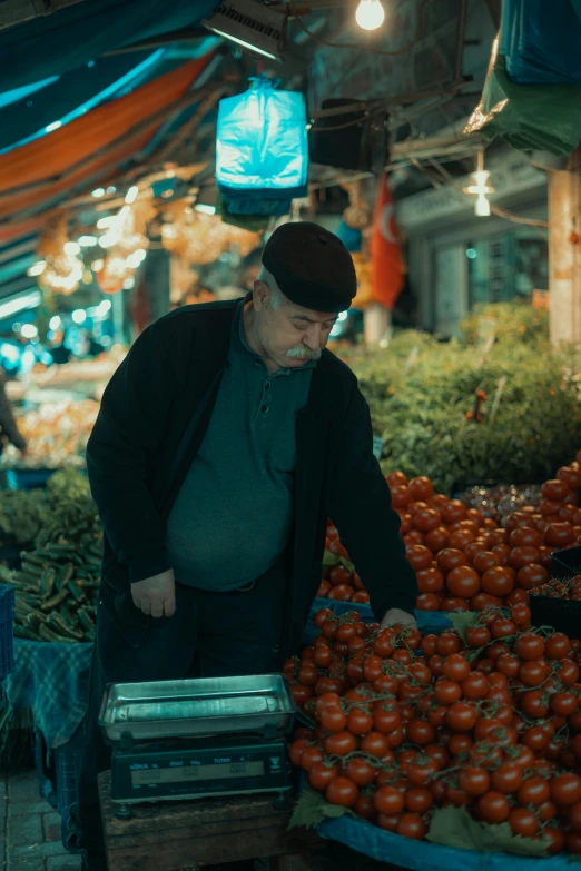 an older man is shopping in an outdoor farmers market