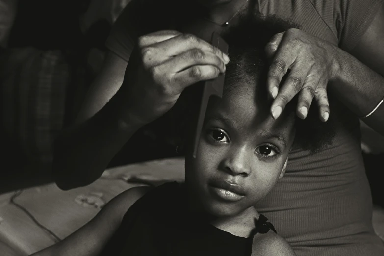 black and white pograph of a girl at the barber