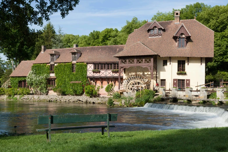 a lake in front of a house and a river running through it