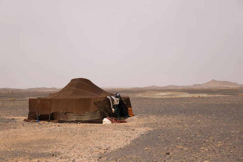 a desert area with a tent and blanket