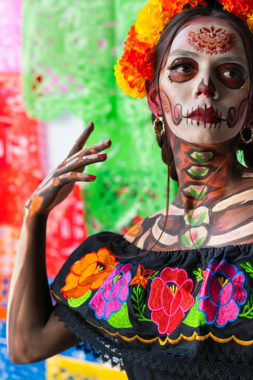 woman with painted face with flowers and red frizzles on her head