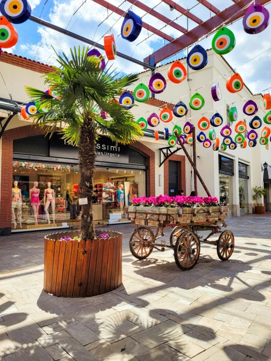 many multicolored umbrellas above an old fashioned carriage