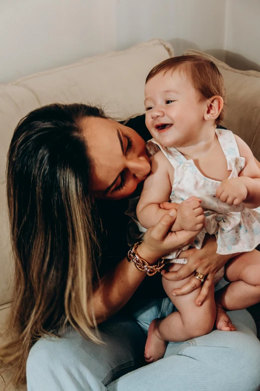 a mom holding her baby daughter with a smile