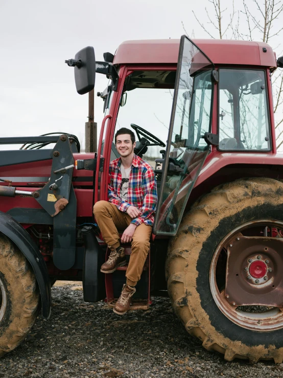 a man sitting in the driver seat of a tractor