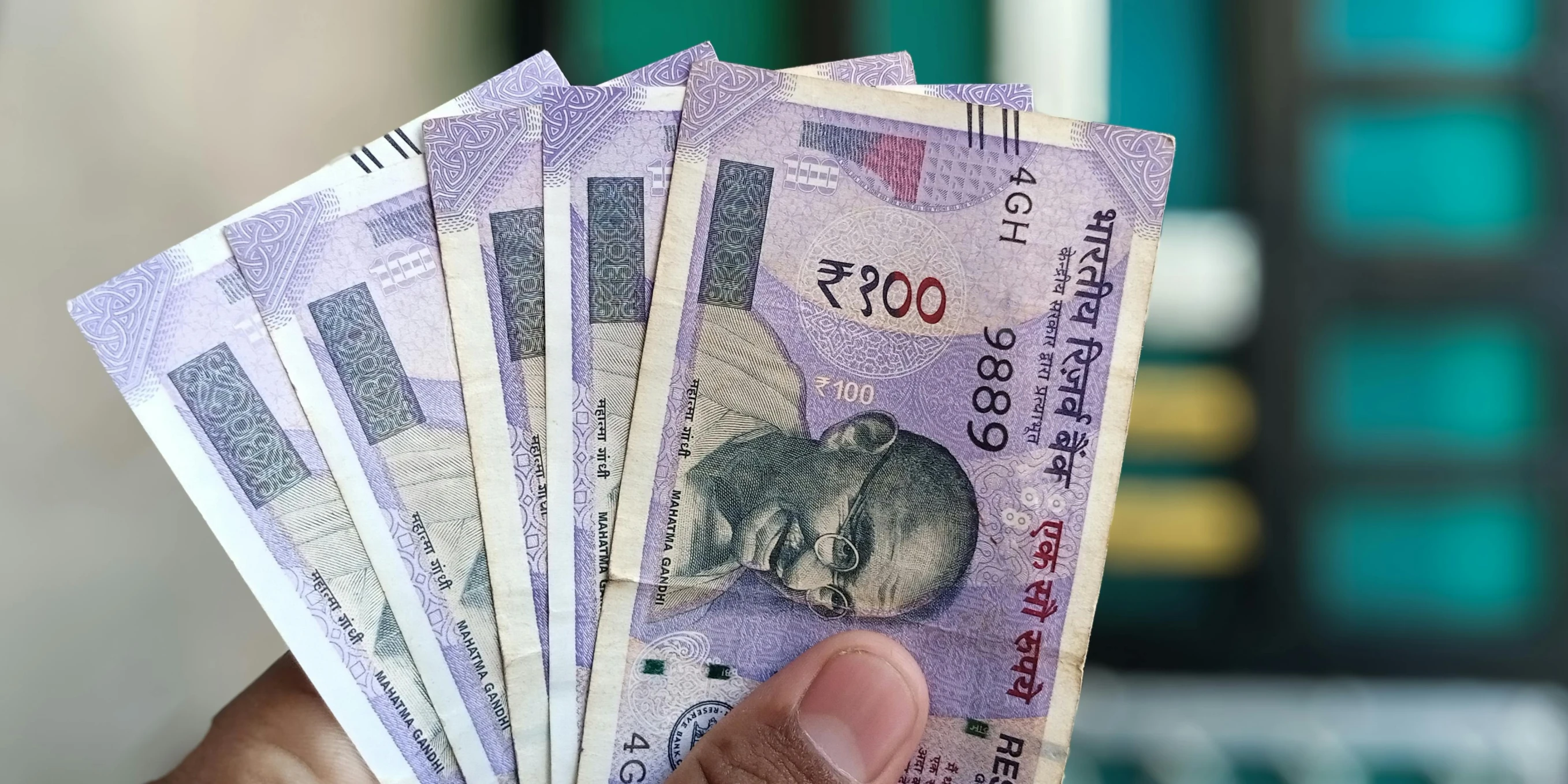 man holding a bunch of chinese currency bills