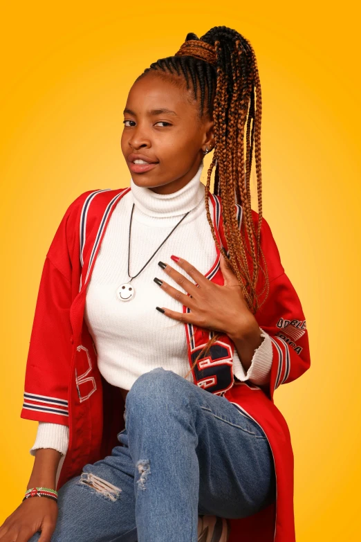 young lady with dreadlocks sitting against yellow background