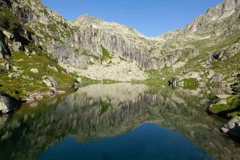 people are in the water with mountains surrounding them