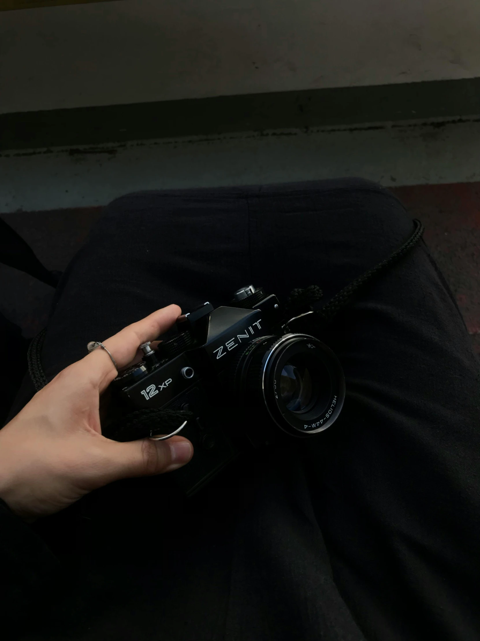 a woman is holding a camera and a black purse