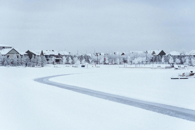 this is the image taken with an old camera of a snow covered residential area