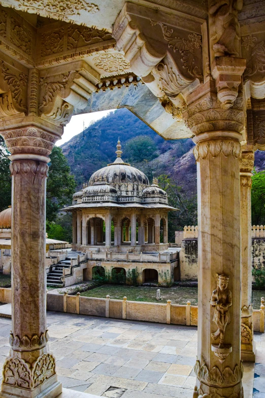 a large gazebo surrounded by tall stone pillars