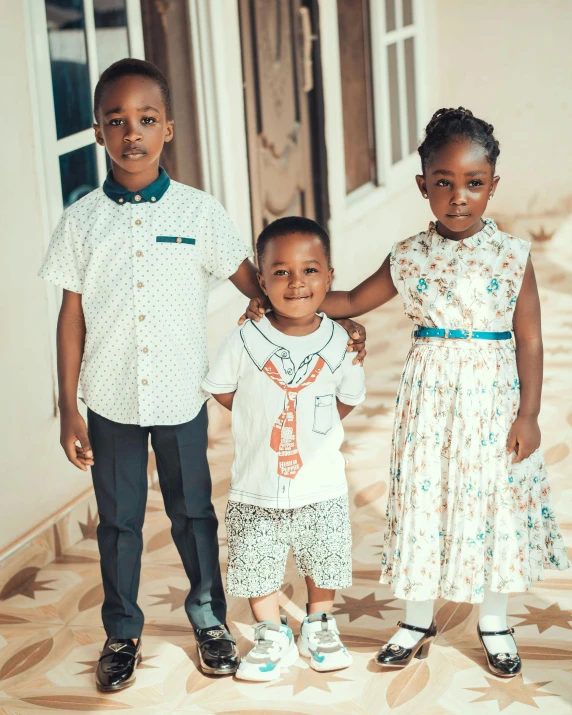 three children are posing together for a picture