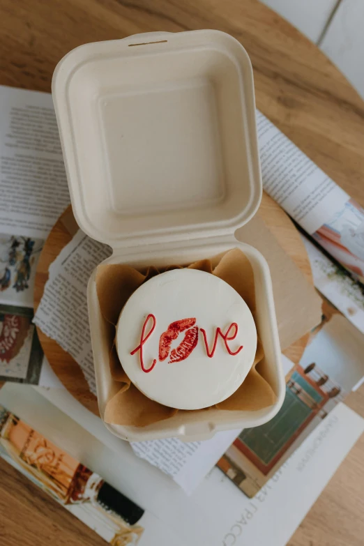 a container of food with a white tray and red writing