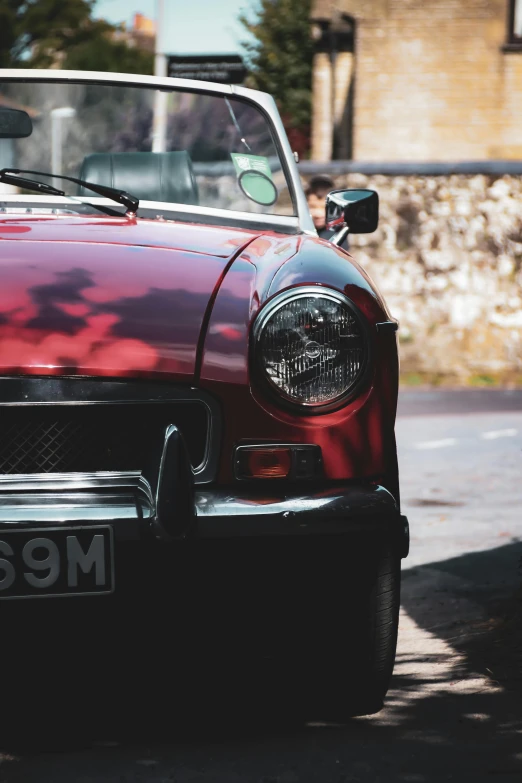 a red and white sports car parked on the side of a road