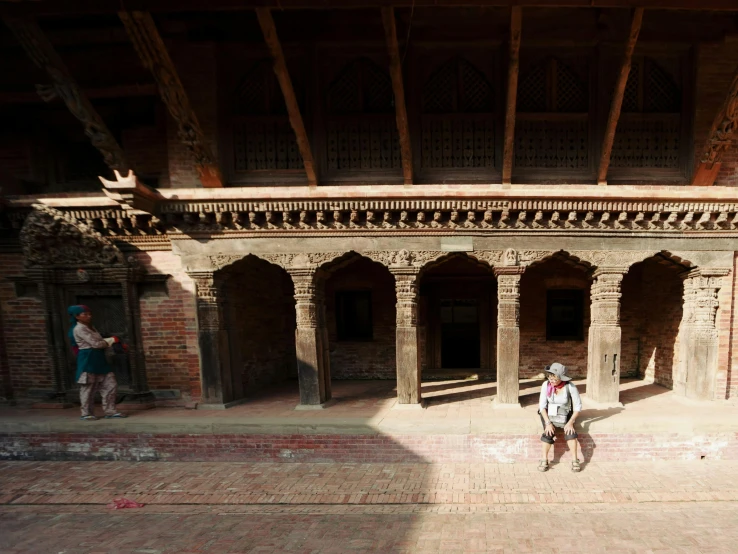 a person standing in the courtyard of a building