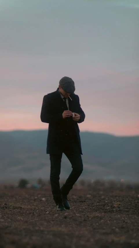 man in black jacket taking a cellphone po