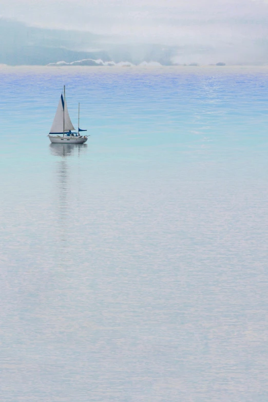 a boat is seen in the water during a cloudy day