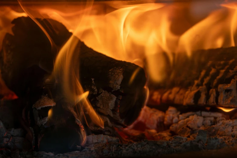 a fire blazing inside of a kitchen stove