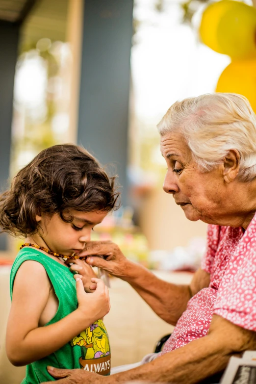 a little girl touches an older man's face