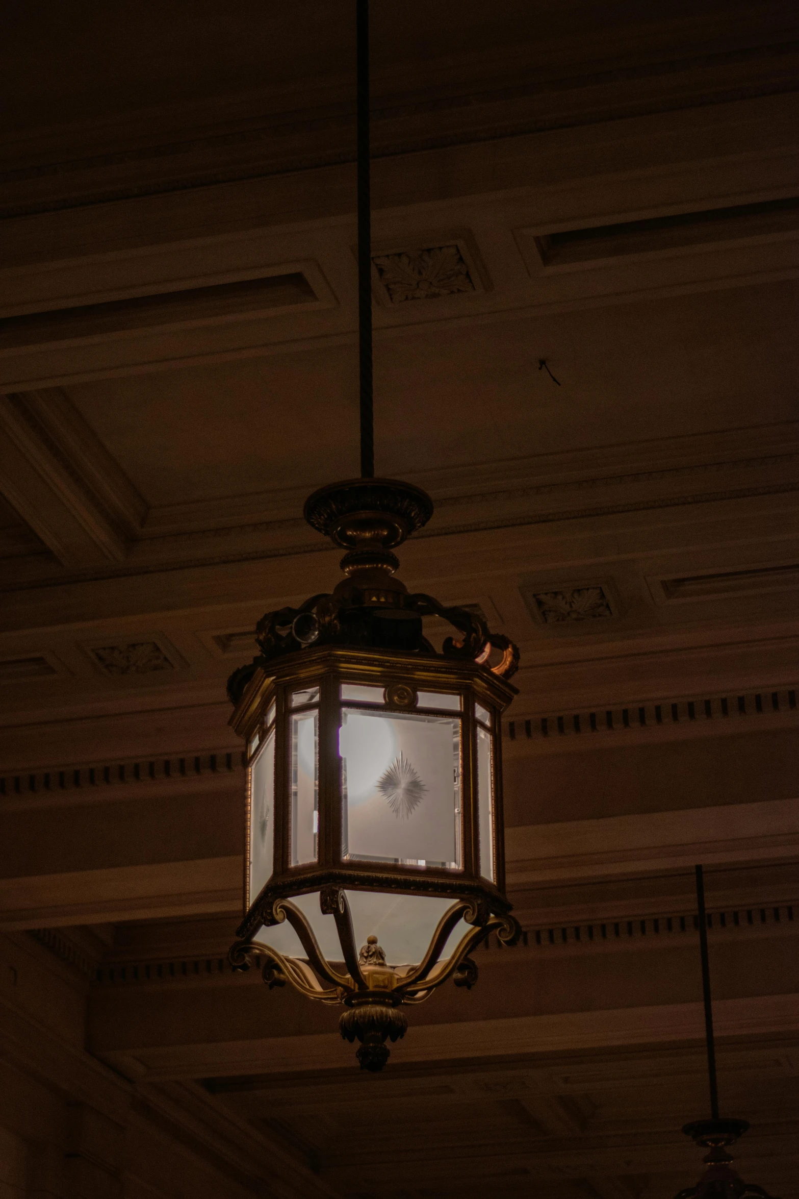 a small chandelier with a lit candle lit up at night