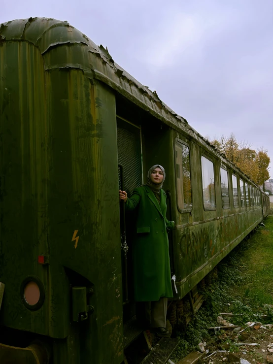 a woman leaning out the door of a train