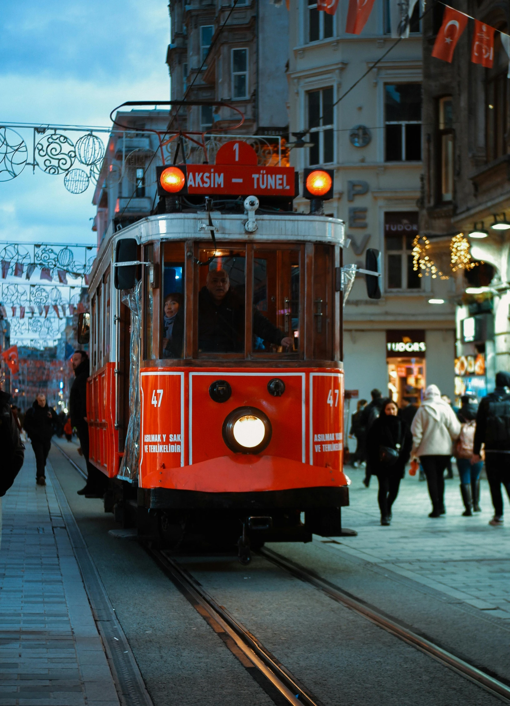 there is a red trolley in the street