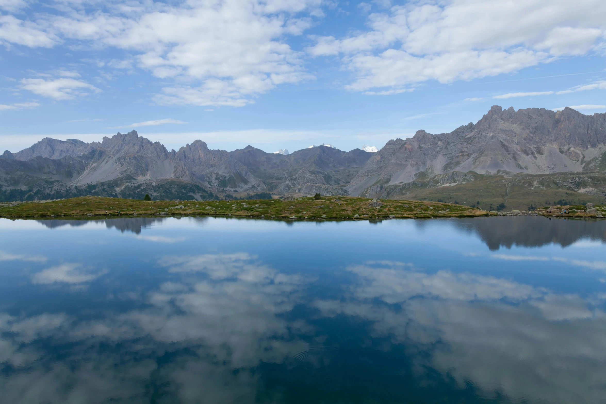 the mountains are reflected in a mountain lake