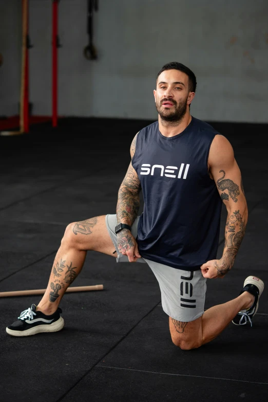 a man posing for the camera in a gym