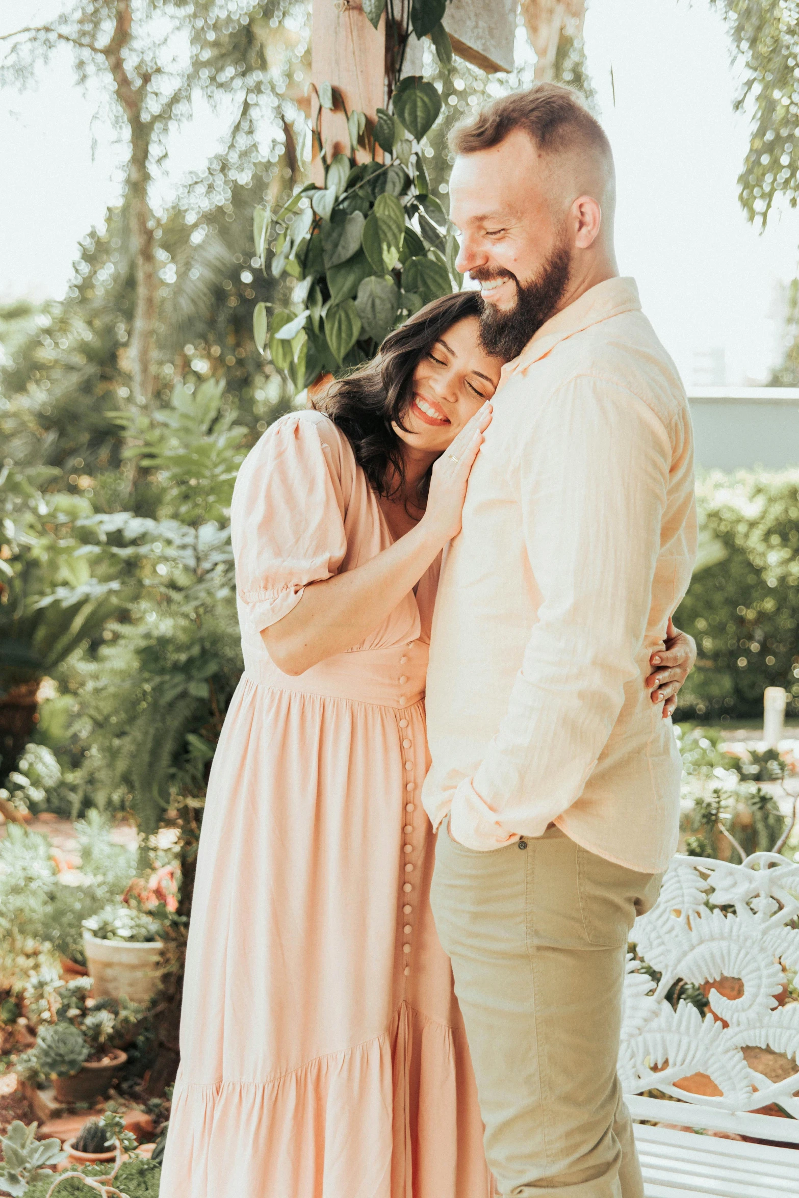 a man and woman hugging on their forehead