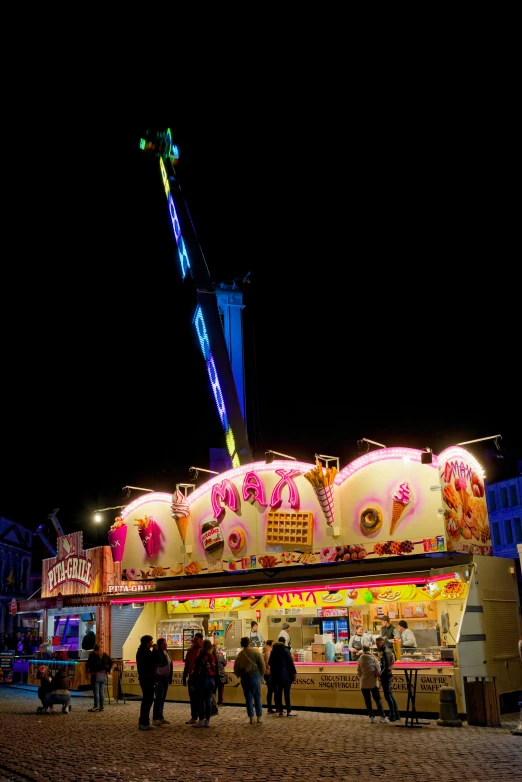 there is a lot of people standing at the fairground