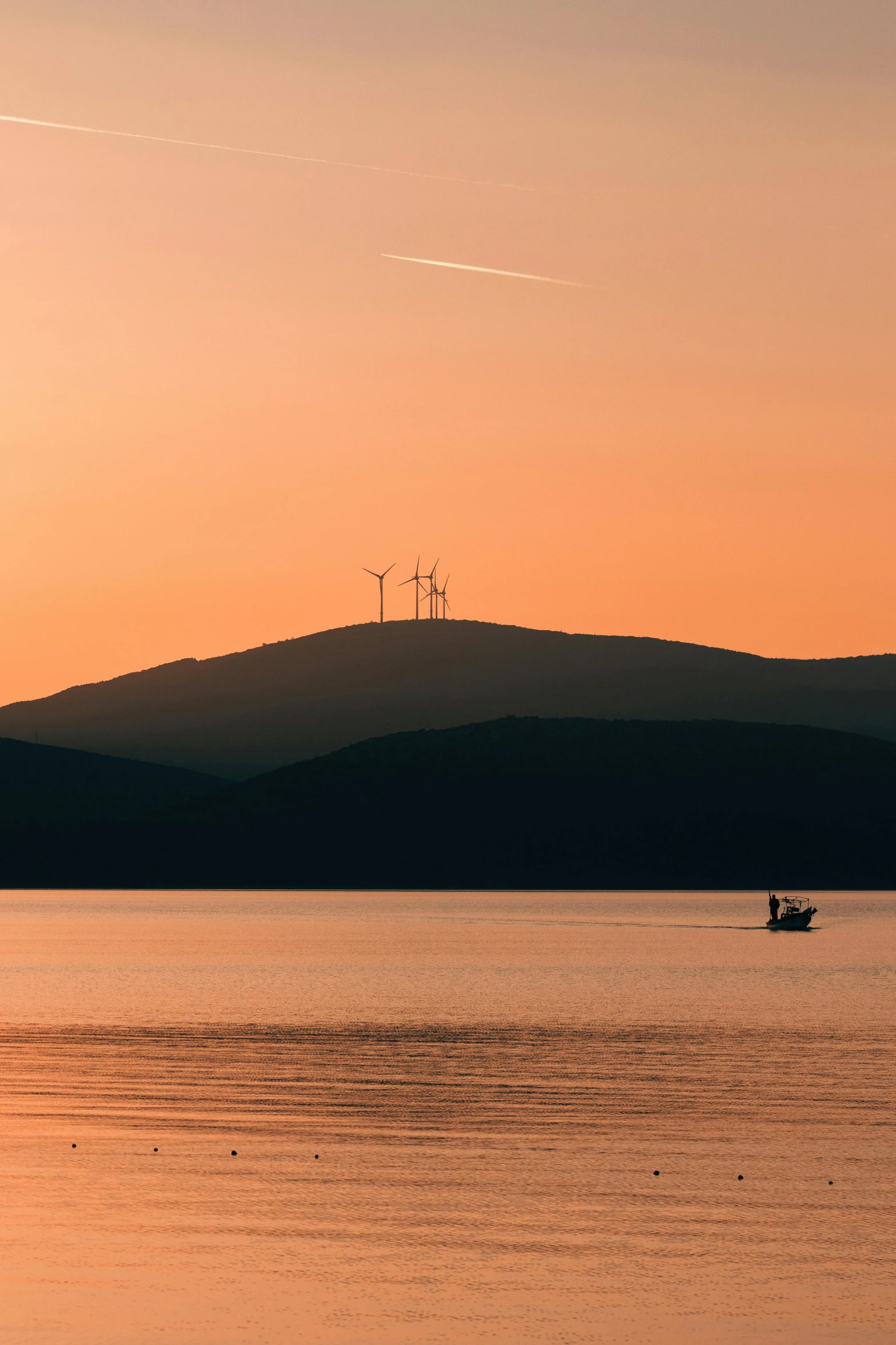 a boat traveling through the water near hills