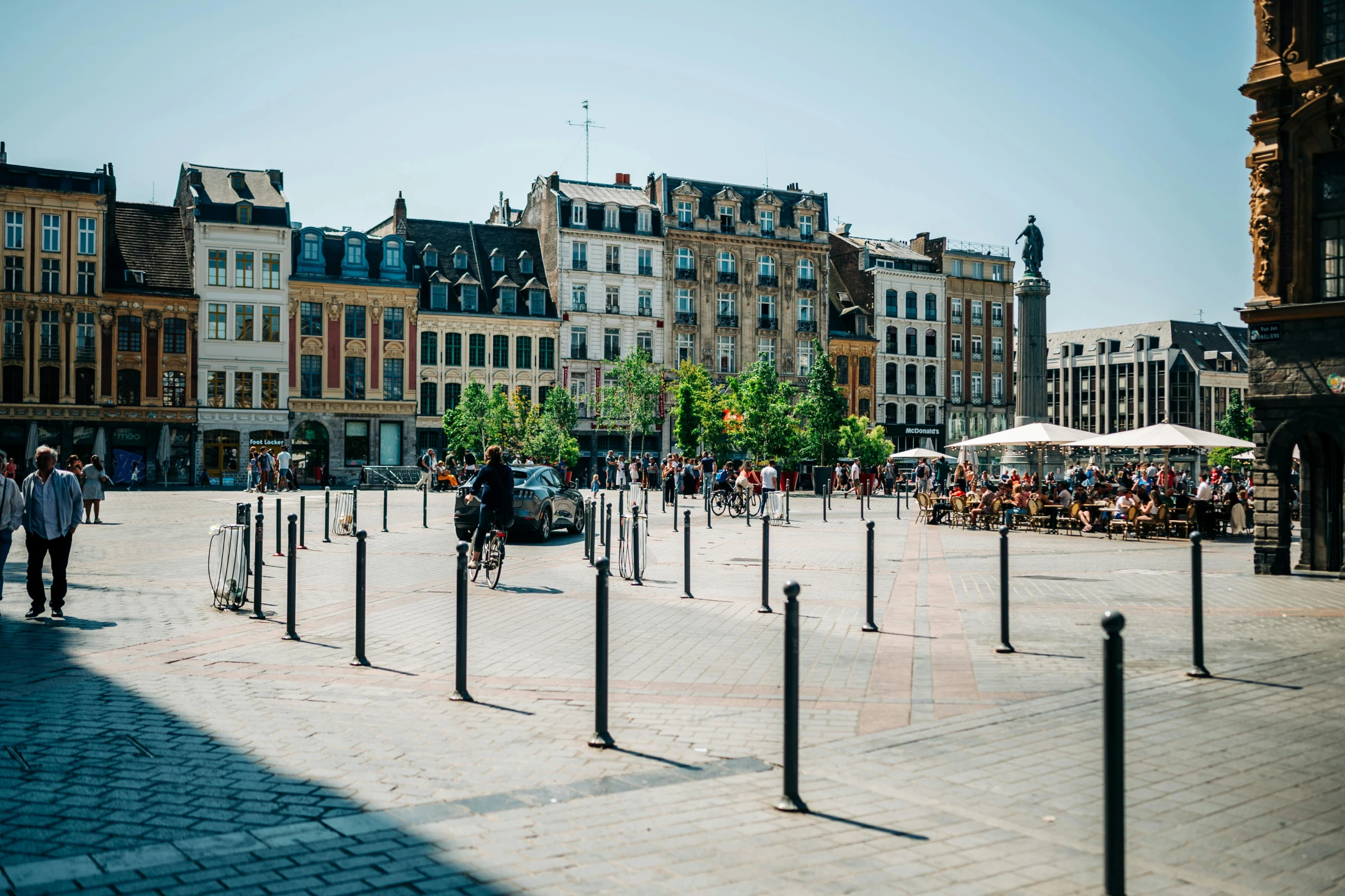 a group of people walking around an old city square