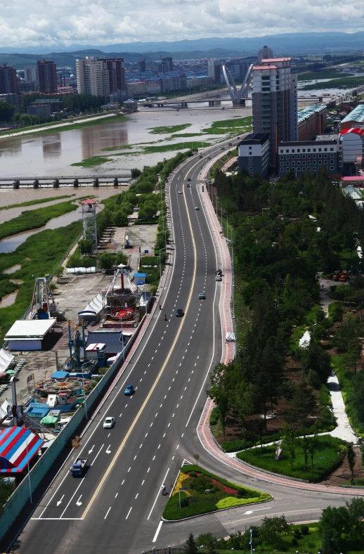 a long highway with several cars on it and other street