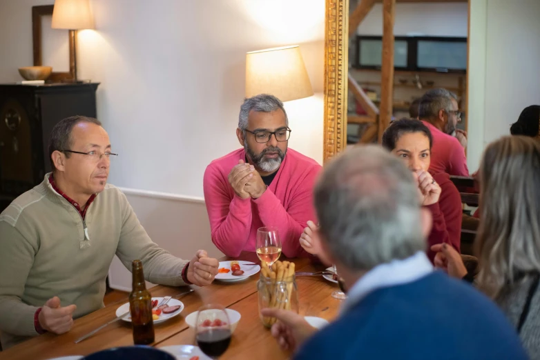 a group of people sit around a table eating