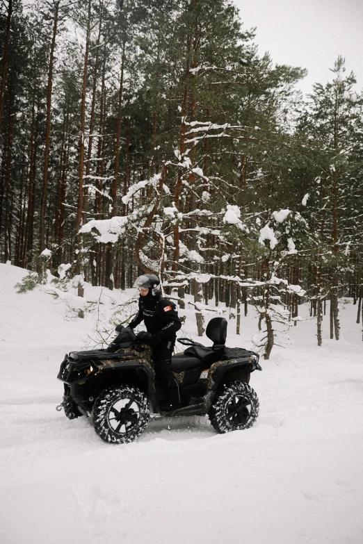 a man is on his atv driving through the snow